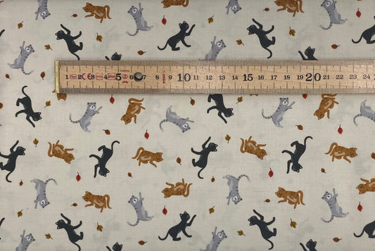 Cats and falling leaves on cream
