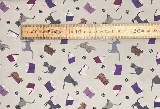 Scattered cats and books on grey