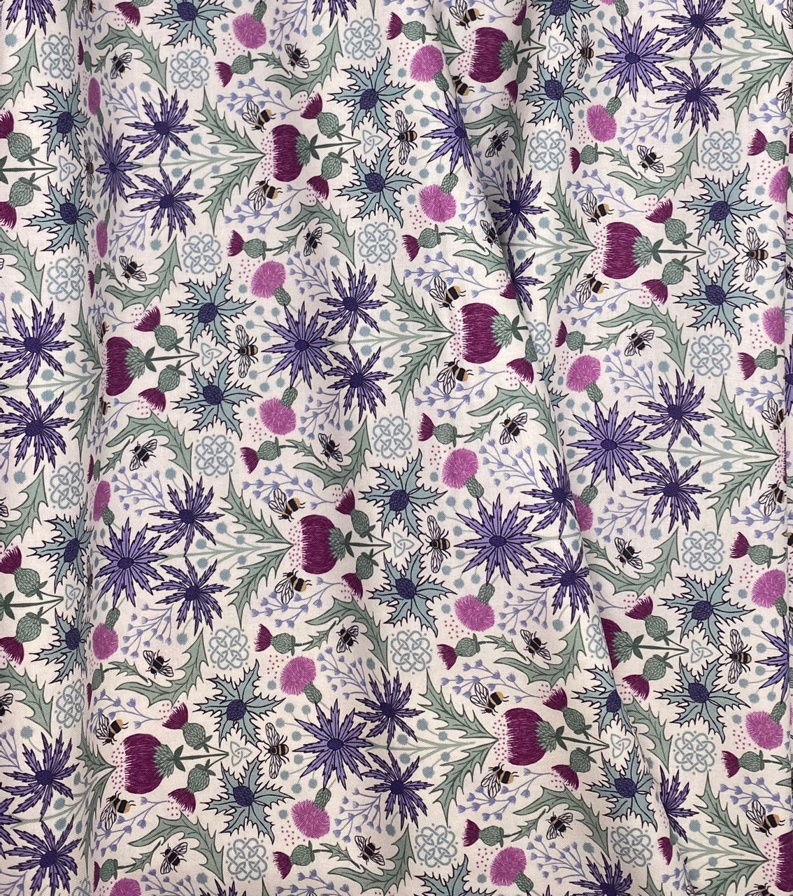 Mirrored thistle and bee on cream