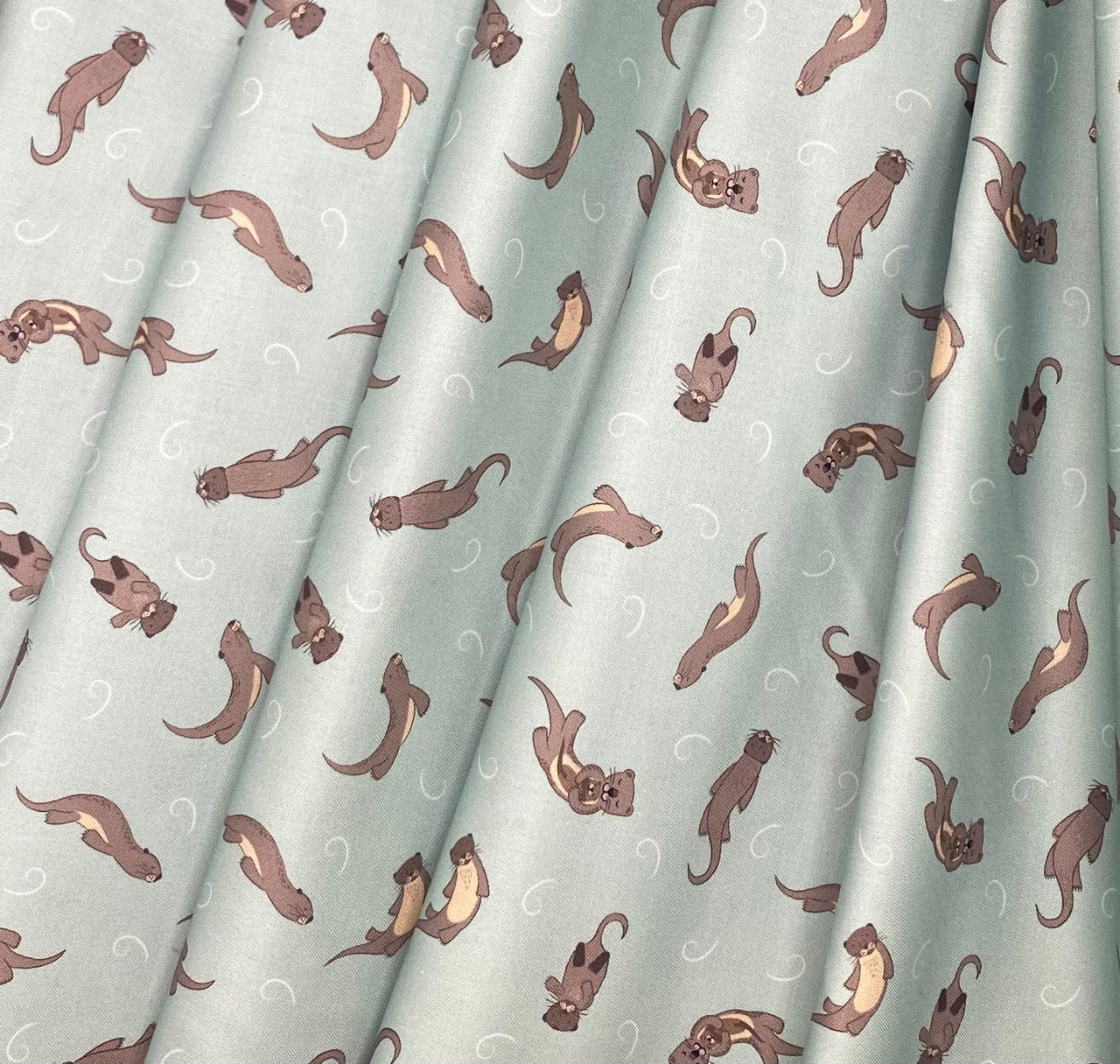 Otters on muted blue