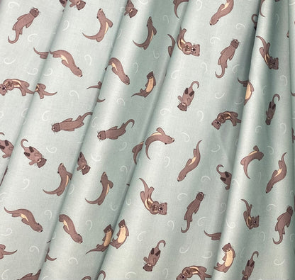 Otters on muted blue