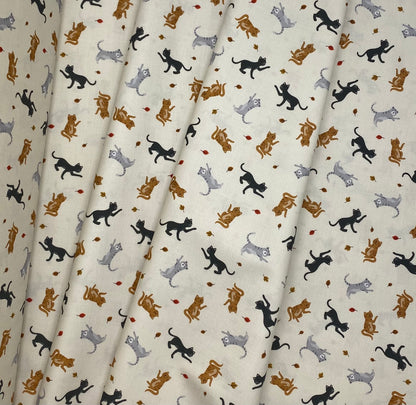 Cats and falling leaves on cream