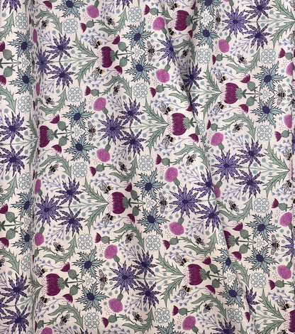 Mirrored thistle and bee on cream