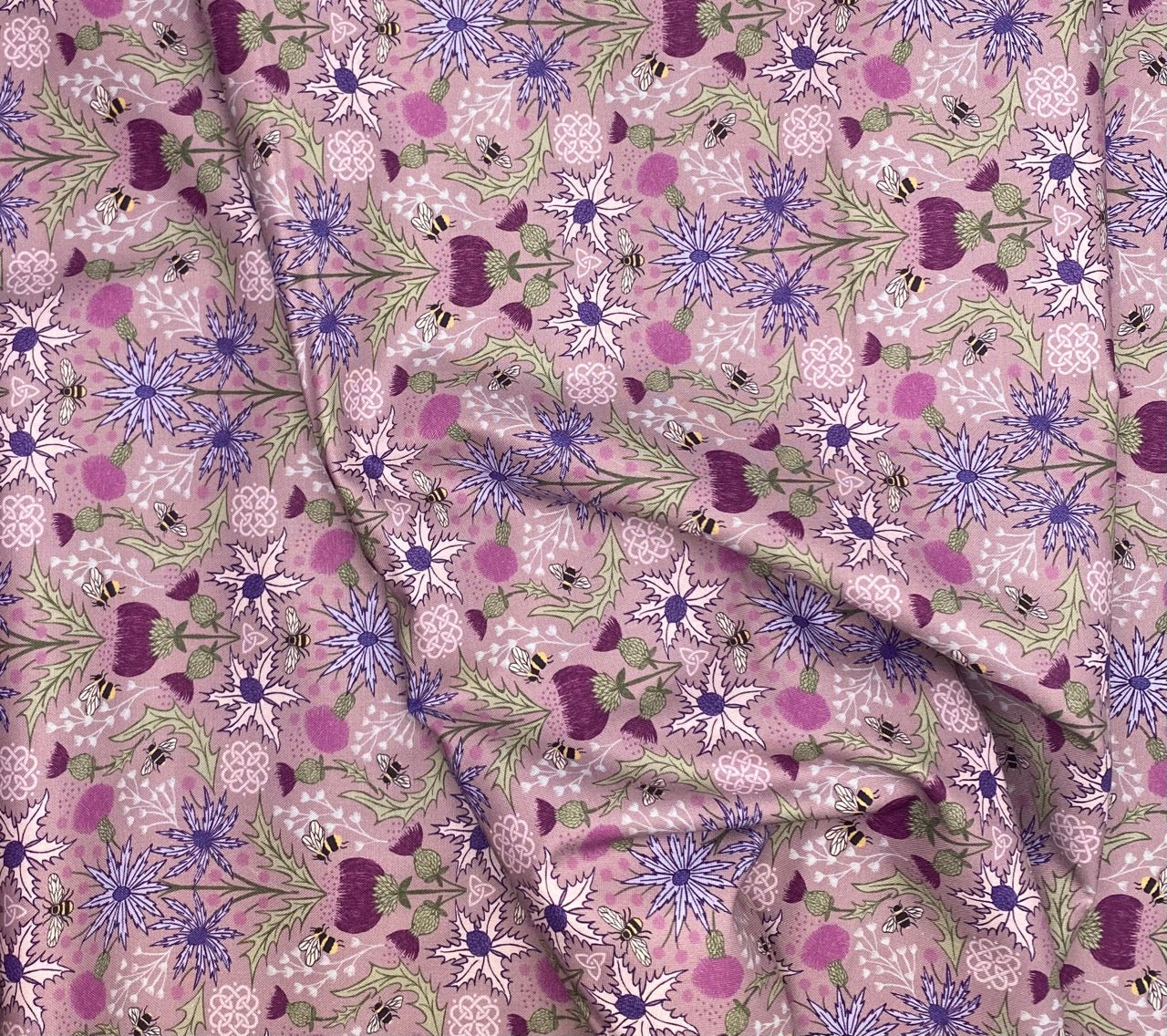 Mirrored thistle and bee on heather